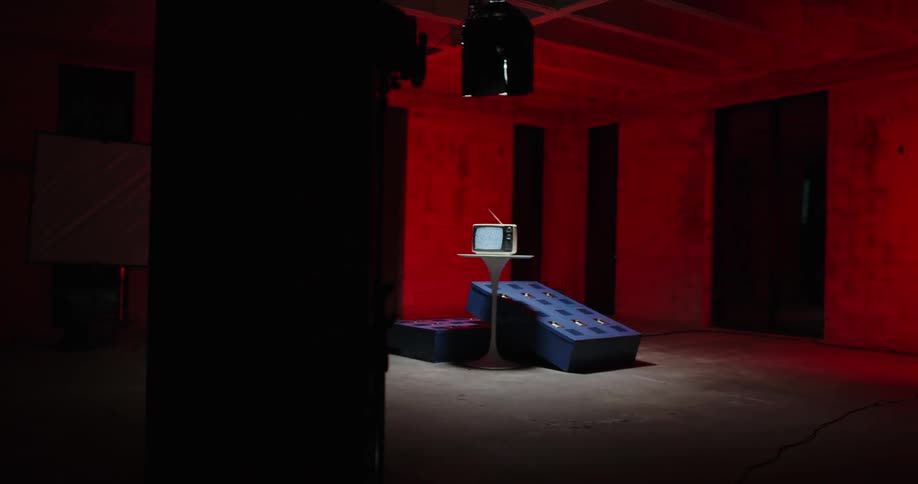 A television sits in the middle of the dark room