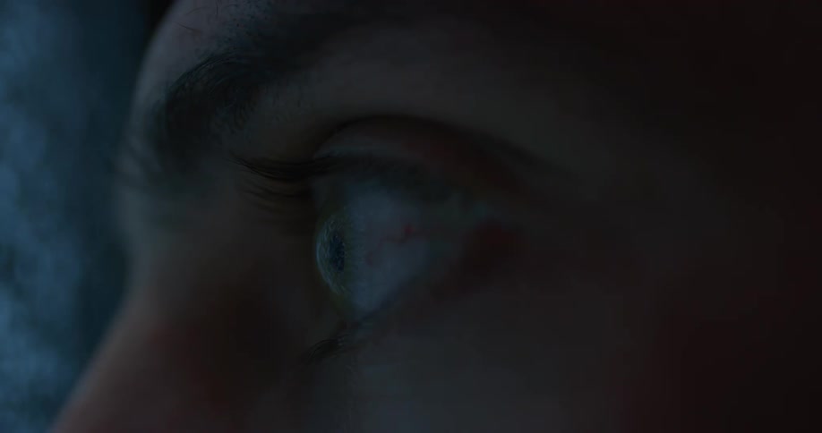 Close up of an eye staring at a screen with static