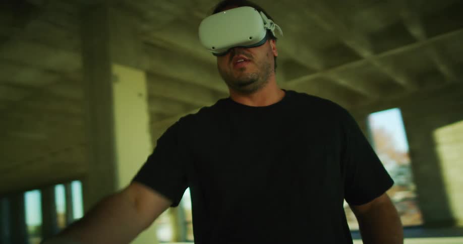A man in a house plays a virtual reality game