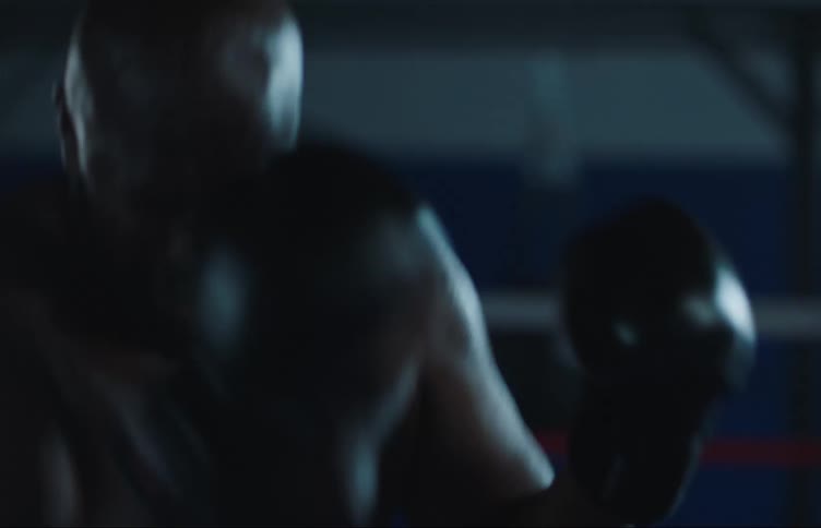 Two black men are fighting in a boxing ring