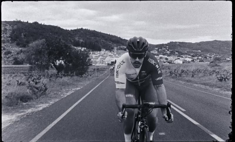 A man races his bicycle on the highway
