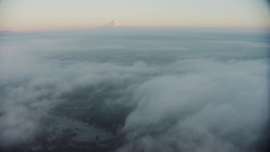 Mount Adams is visible rising above a vast sea of early morning fog on a frigid winters morning