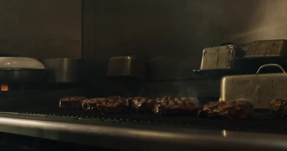 The burgers are cooking on the grill