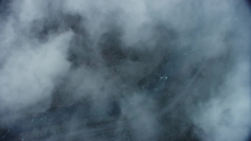 Looking down at a whitewater river from the perspective of a passenger in a commercial jet liner crossing the United States