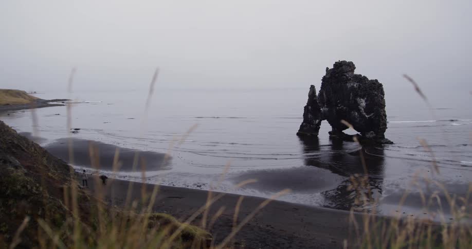 A rock formation sits near the shore