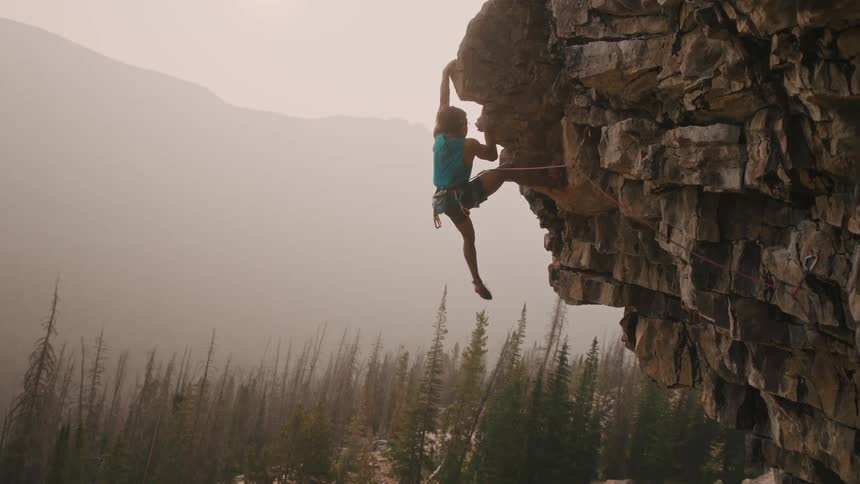 A person climbing up a rock
