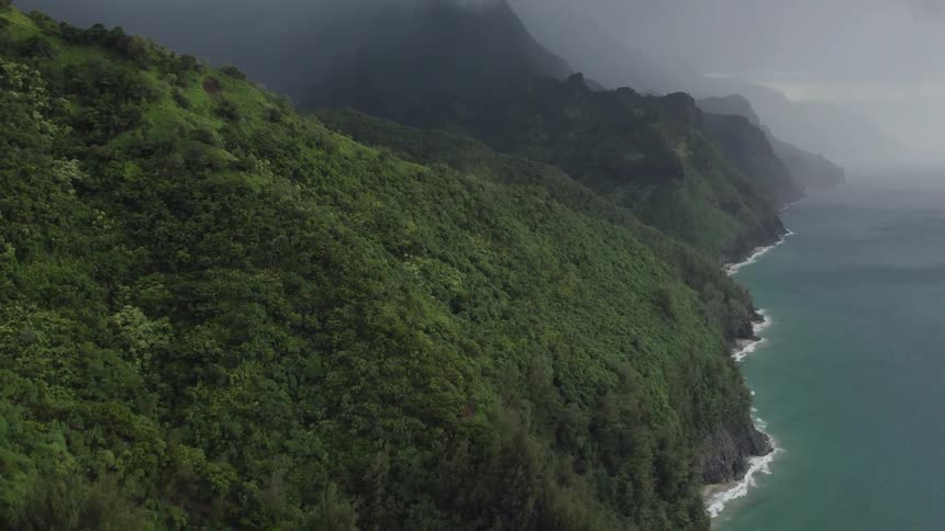 Aerial view shoreline with mountain forest in fog