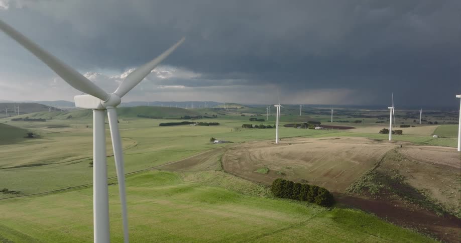 An aerial view of storm clouds over a wind farm