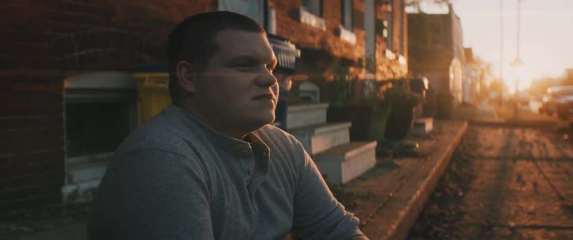 Person sitting on curb