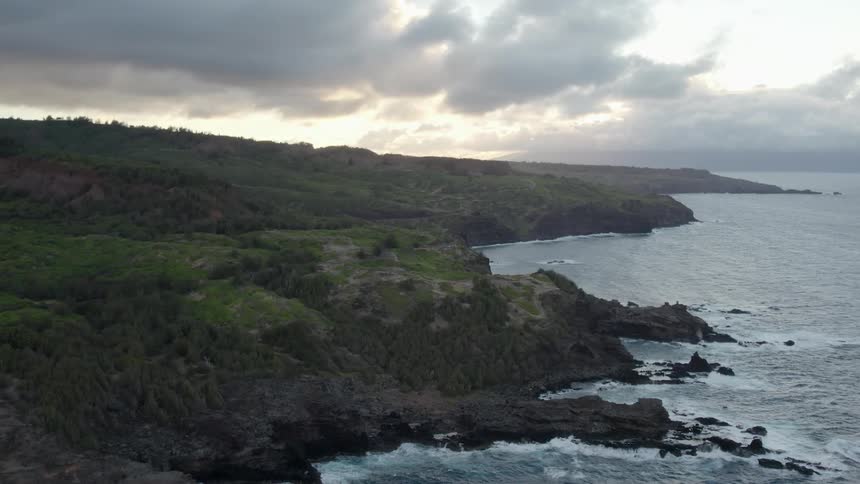 The waves are crashing against the island shore