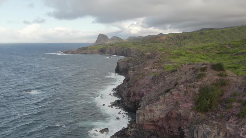 The ocean is crashing against the island shore