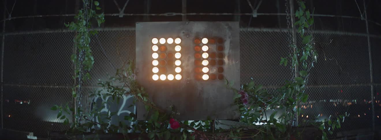 A shot clock counts down to zero at night