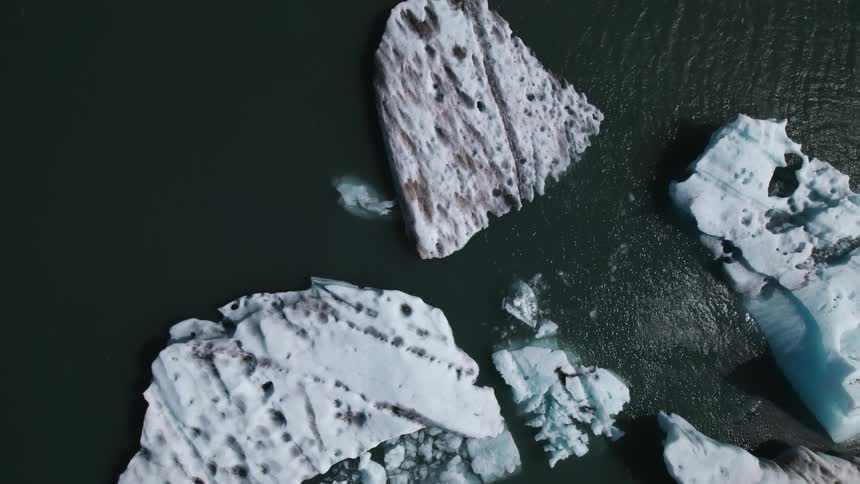 The water near the shore is covered with ice
