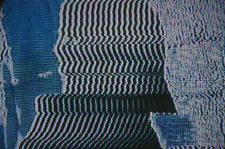 The silhouette of mans head on a screen as his hand is moving his hat surrounded by white and blue lines
