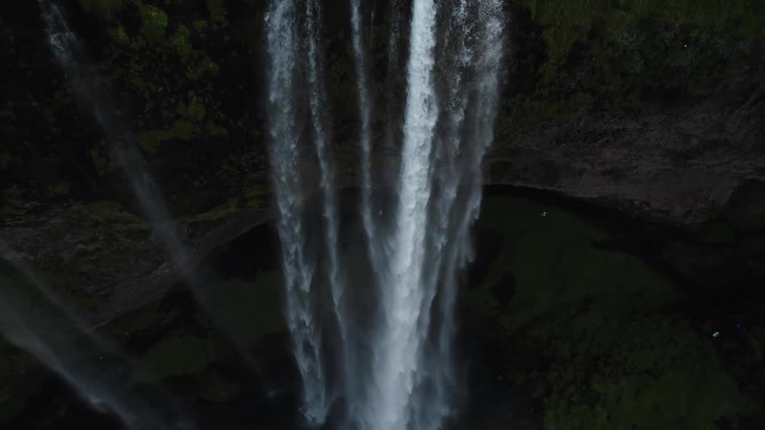 A view of a waterfall at the edge of a cliff