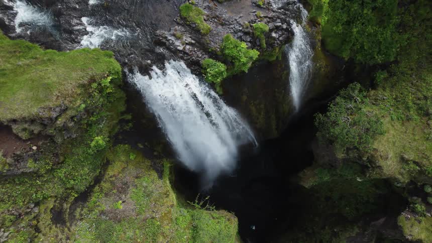 Aerial view of waterfall cascading down cliff