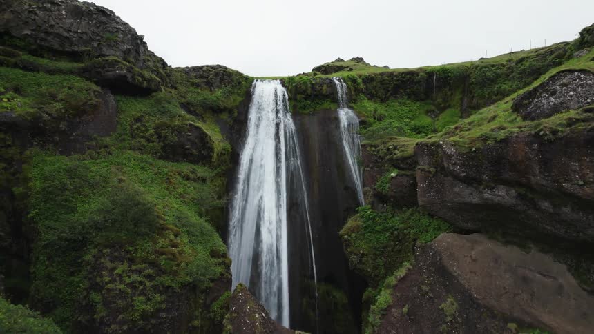 An aerial view of a waterfall coming from a river