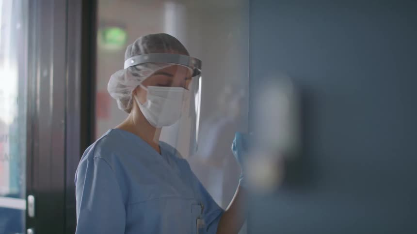 A doctor moves through the door