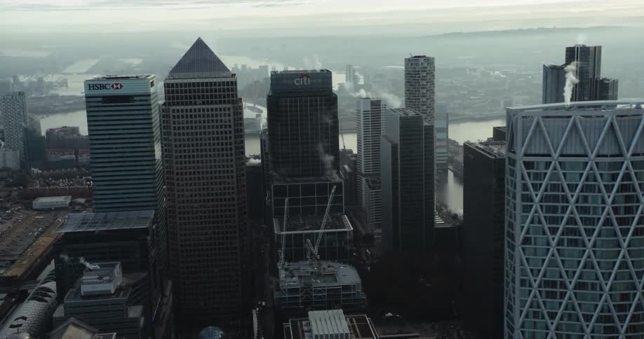 Skyscrapers along a river in a metropolis on a foggy day