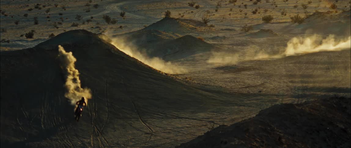 A person jumping a dirt bike off a hill