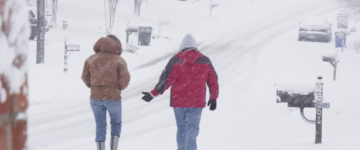 People walking outdoors in a snowstorm