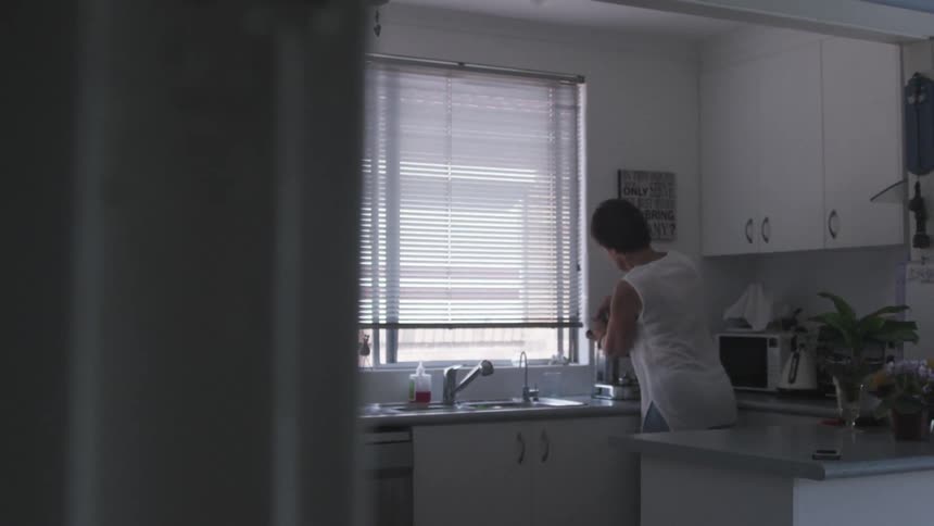 A person standing in a kitchen