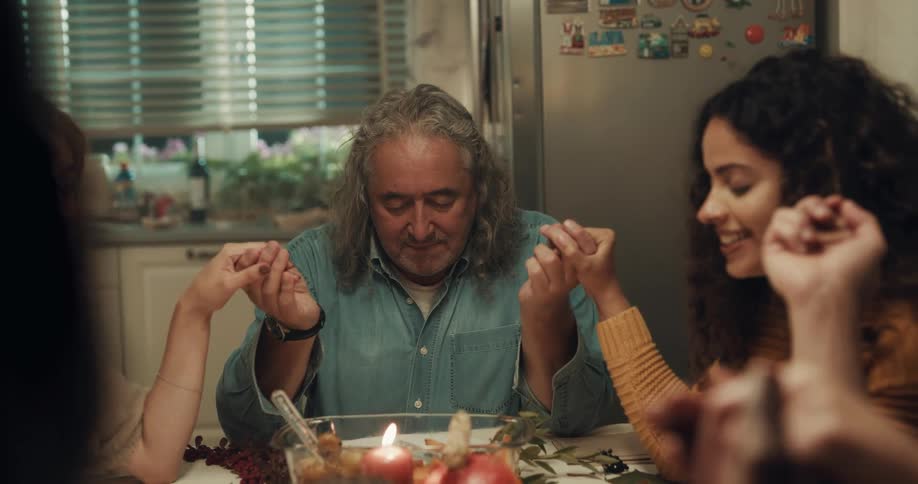 A family say a prayer before dinner