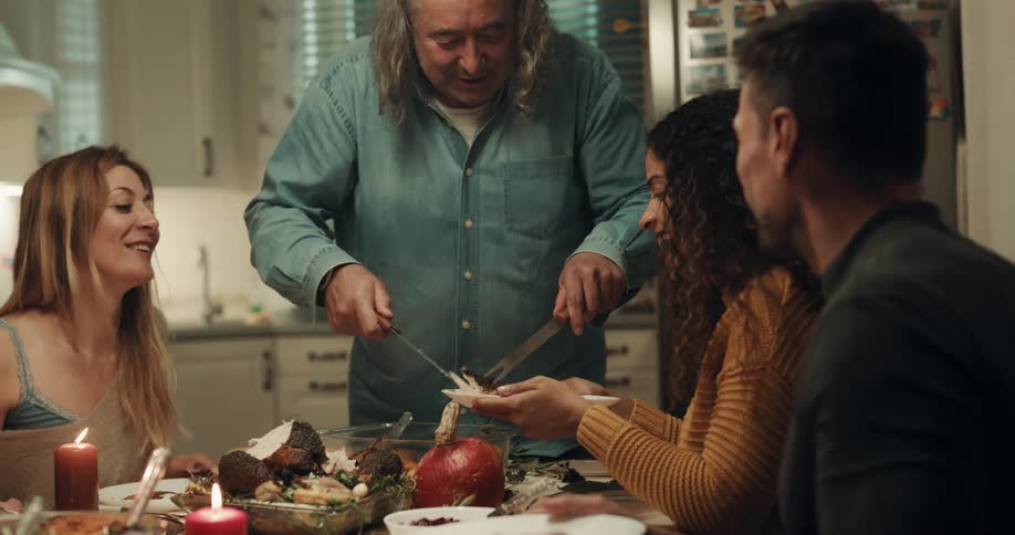 A man carves the chicken for dinner
