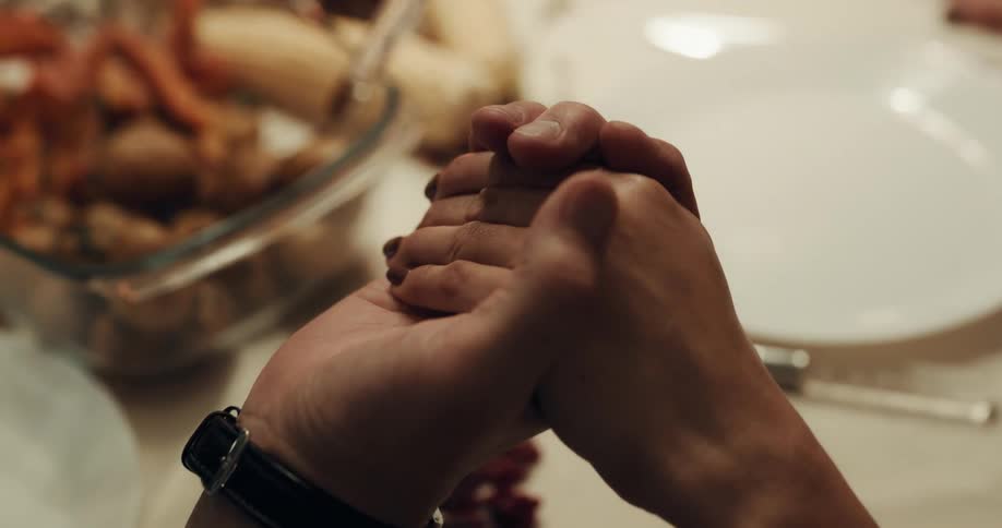 Two people holding hands at a table