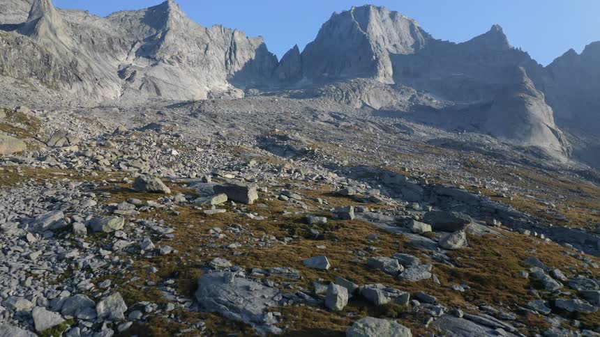 A mountain slope covered in rocks under a clear sky