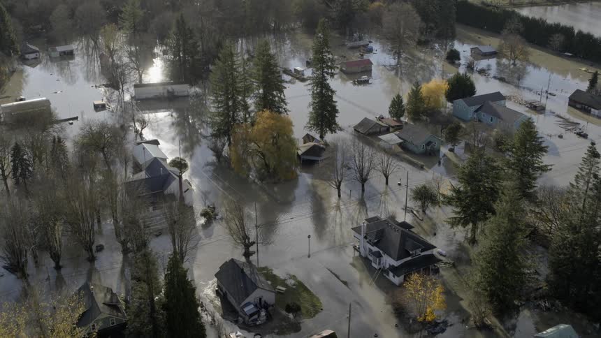 Flying over water damaged homes in a flooded neighborhood