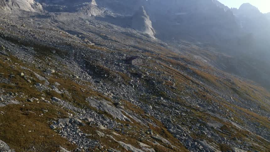 A single house is on the side of the mountain