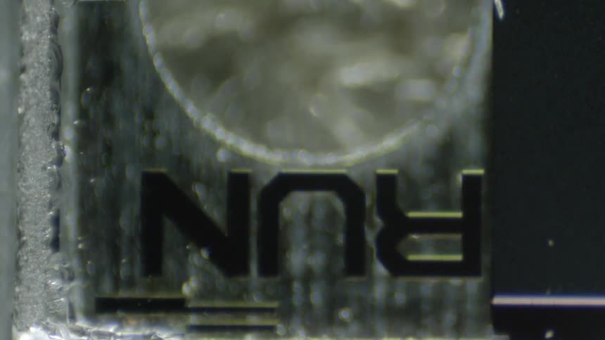 The word run sits upside down and backward on glass