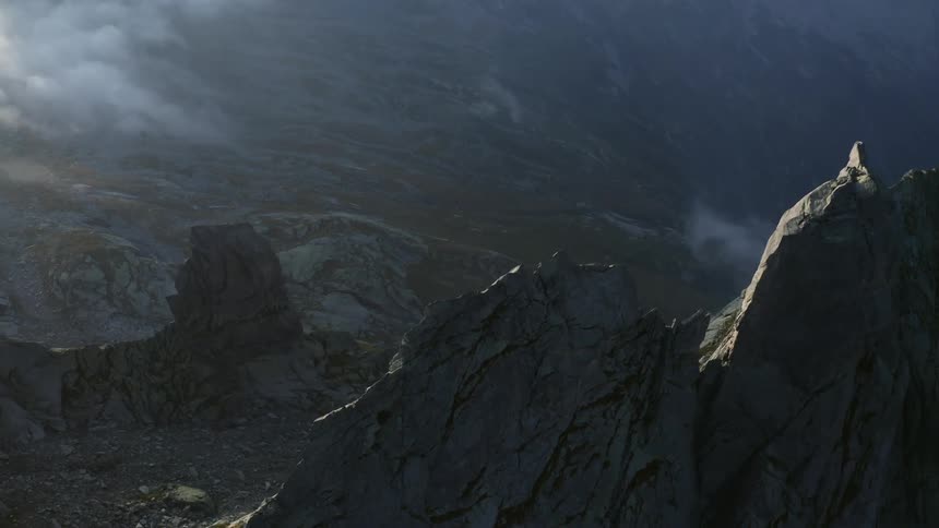 Clouds are hanging low beneath tall mountain peaks