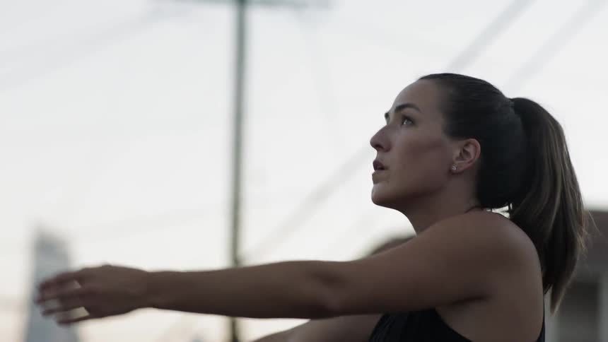A woman stretches outdoors