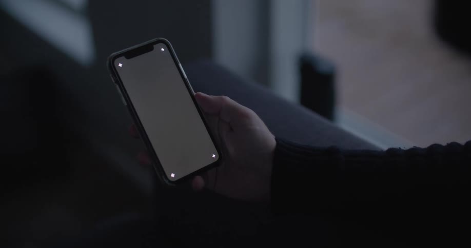 Close up of a person holding a cell phone with a blank screen