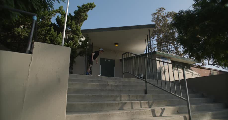 Young man tries to jump over the stairs on the street and fails