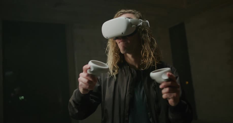 A man is swinging his arms around as he plays a virtual reality game