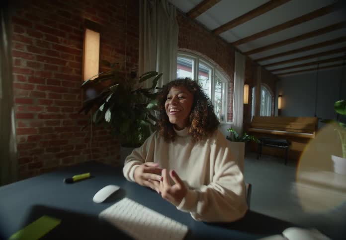 Woman laughing and talking on a zoom call working remotely