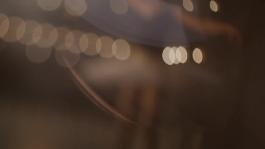 Ballerina dances on stage under theater lights