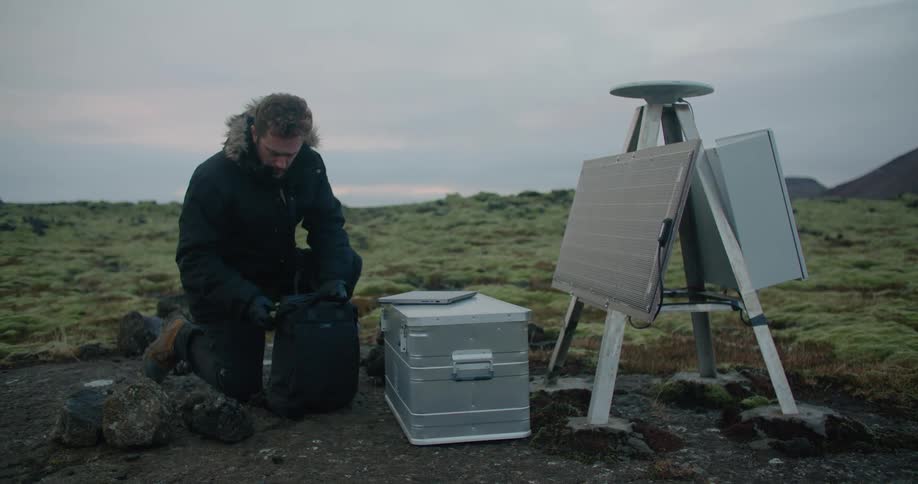 A man is setting up a machine outside