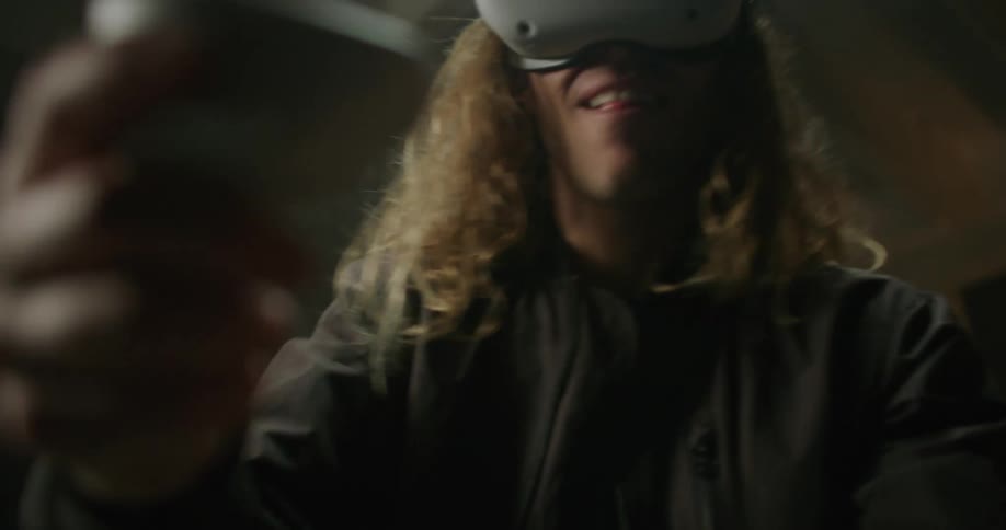 A man is swinging a controller while using virtual reality
