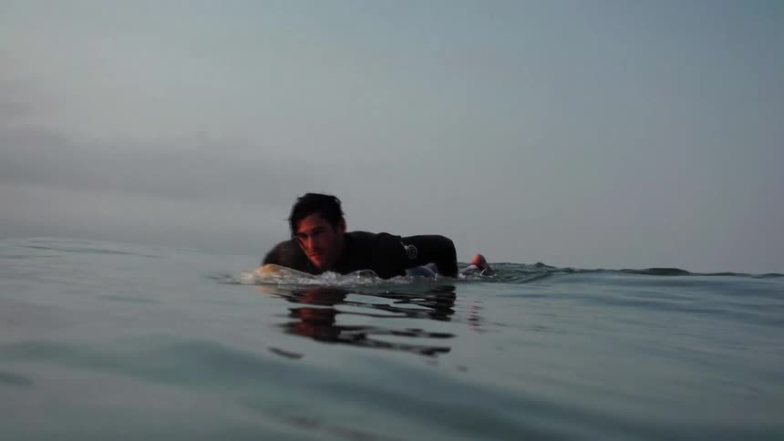 Guy Surfing On Coast