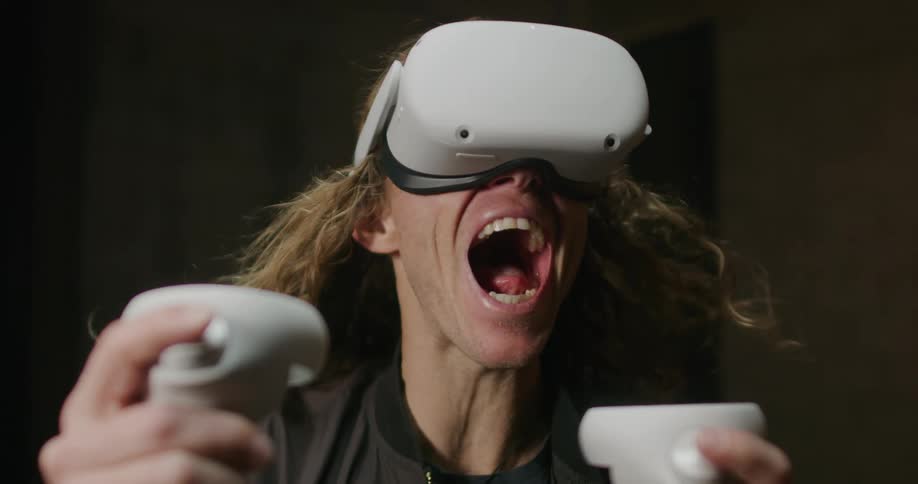 A man yells out loud while using a virtual reality headset