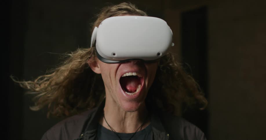 A man shouts while using a virtual reality headset