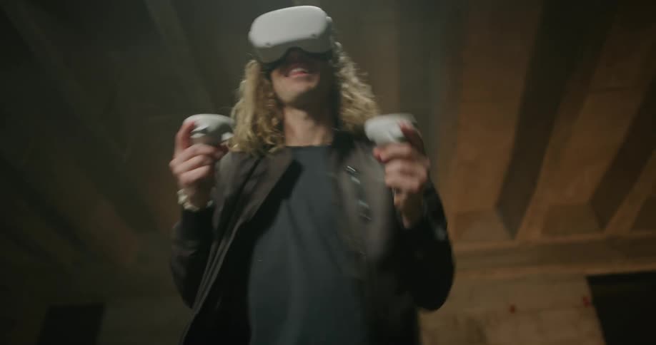 A man is throwing punches while he plays with a virtual reality headset and controllers