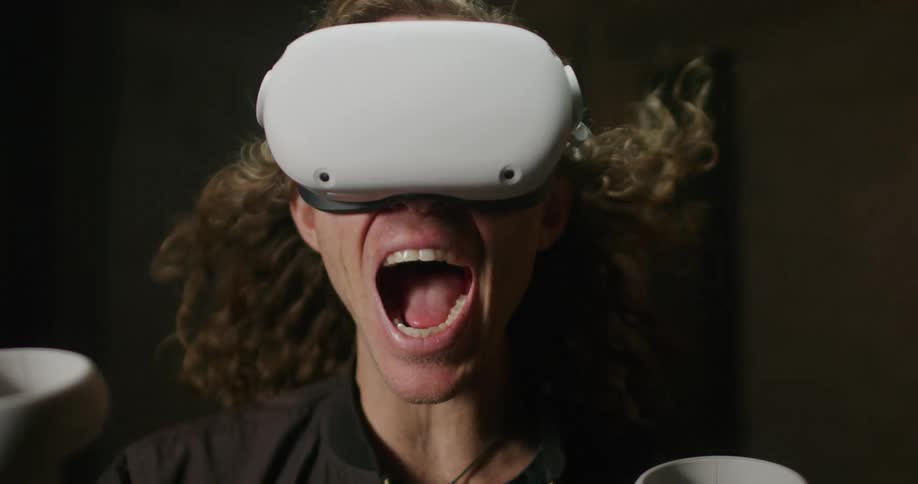 A man is screaming while he uses a virtual reality headset
