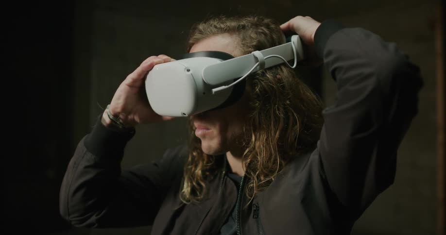 Blonde man puts on vr headset