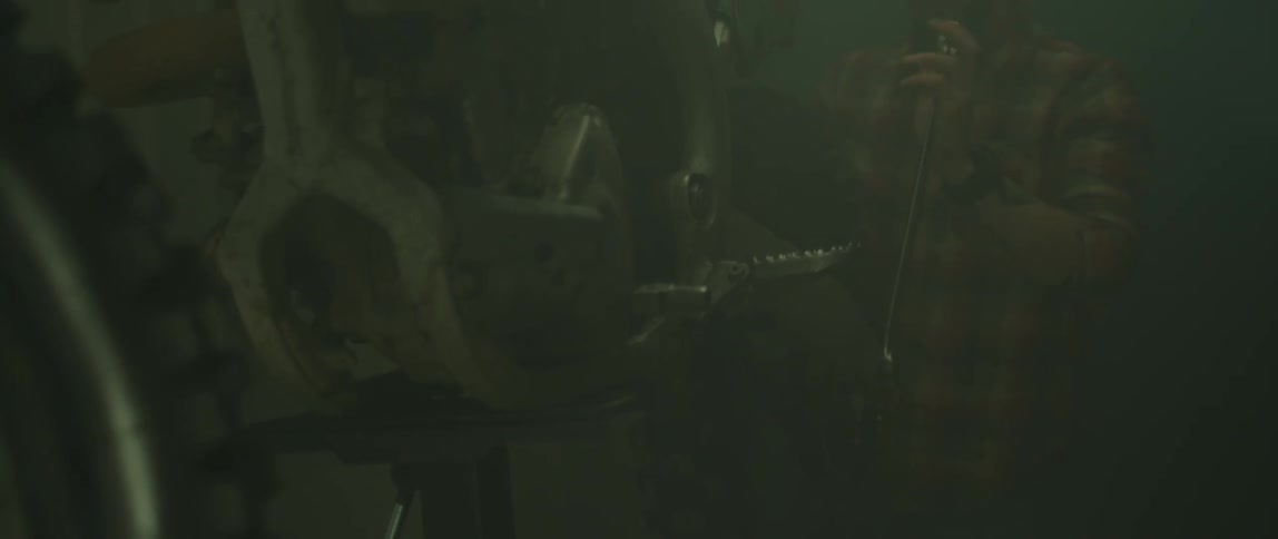 A mechanic is working on an engine