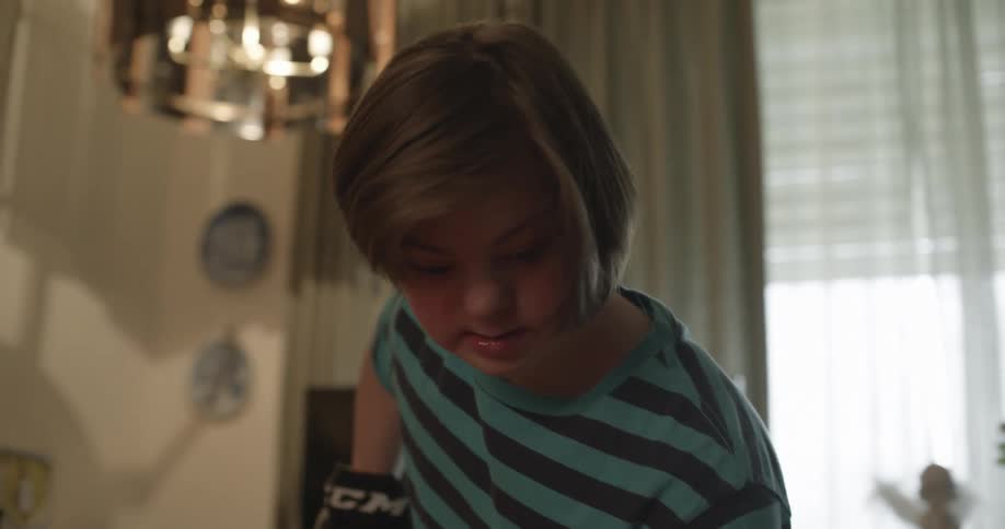 Girl plays game with stick in room
